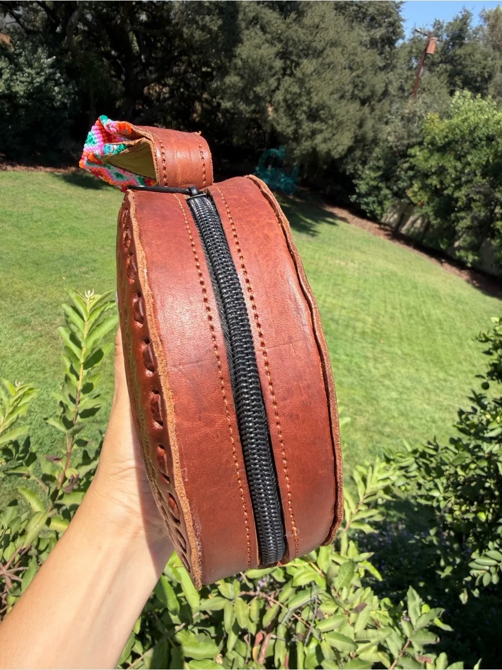 Hand-Tooled Round Leather Wristlet Bag with Colorful Woven Strap